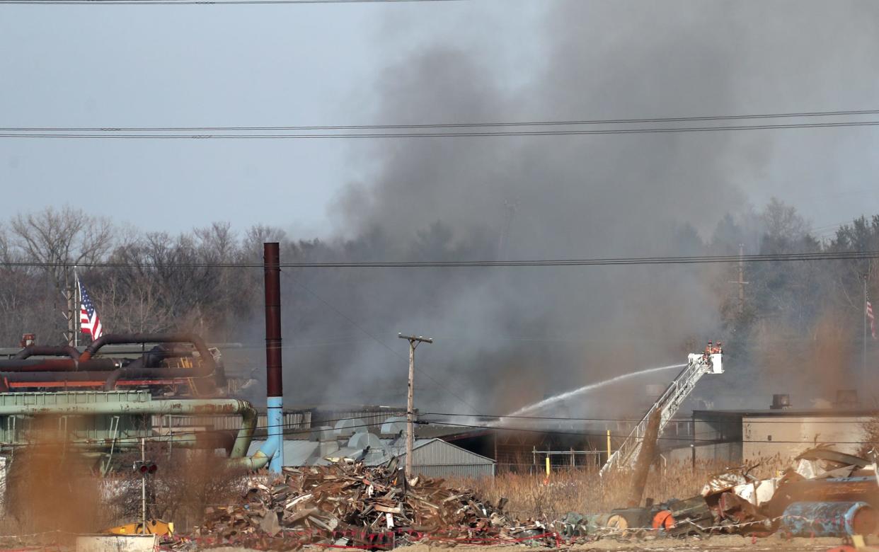 A ladder truck sprays water  on a fire at I. Schumann & Co. in Oakwood on Monday. Multiple agencies responded to the fire and explosion.