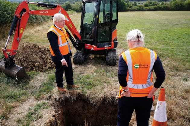 Britain's Prime Minister Boris Johnson (L) and Britain's Culture Secretary Nadine Dorries (R) look at a hole during a visit to the Henbury Farm in north Dorset, on August 30, 2022 as Wessex Internet company is laying fibre optics in the field. - Boris Johnson's visit marks a new data showing that 70 percent of the United Kingdom is now benefiting from gigabit broadband coverage. (Photo by Ben Birchall / POOL / AFP) (Photo by BEN BIRCHALL/POOL/AFP via Getty Images) (Photo: BEN BIRCHALL via Getty Images)