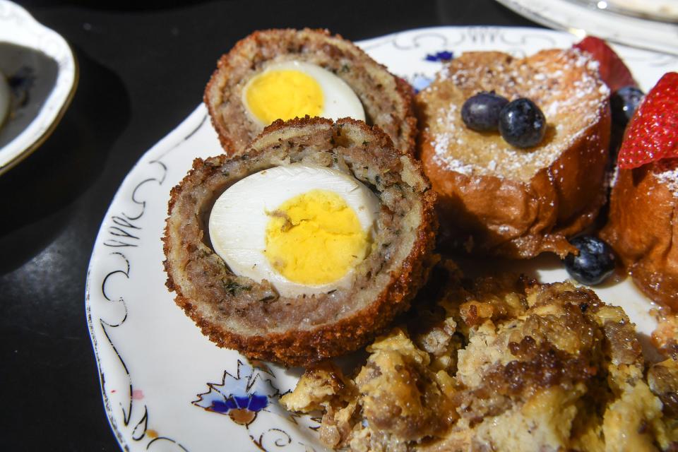 Scotch eggs on a breakfast plate.