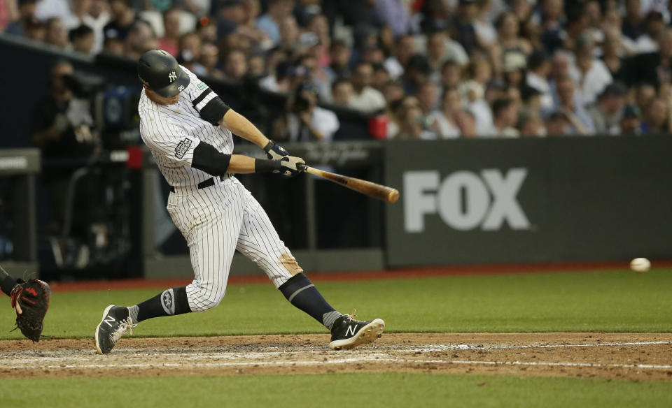 New York Yankees' DJ LeMahieu hits an RBI single against the Boston Red Sox during the fifth inning of a baseball game, Saturday, June 29, 2019, in London. Major League Baseball made its European debut game Saturday at London Stadium. (AP Photo/Tim Ireland)