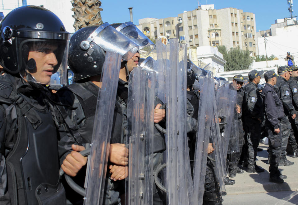 Riot Police face demonstrators during a rally against Tunisian President Kais Saied in Tunis, Tunisia, Sunday Nov. 14, 2021. A 40-year-old Tunisian computer engineer turned corruption fighter will stand trial again in a military court Monday Sept. 22. He is accused of insulting the presidency and defaming the army. It is the latest in a series of trials that shine a light on Tunisia’s use of military courts to push through convictions against civilians. (AP Photo/Hassene Dridi, File)