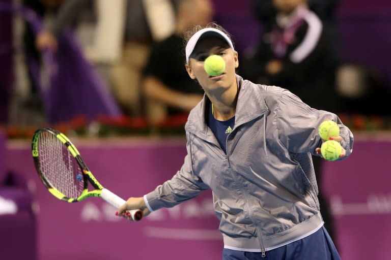 Nose for victory: Caroline Wozniacki hits balls into the crowd after her feisty win over Monica Niculescu at the Qatar Open