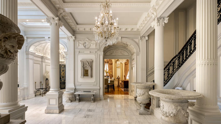 The white marble hall with a breathtaking chandelier - Credit: Evan Joseph