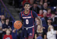 FILE - Detroit Mercy guard Antoine Davis brings the ball up during the second half of the team's NCAA college basketball game against Gonzaga in Spokane, Wash., Dec. 30, 2019. Davis, the nation's leading scorer, broke the Division I record for career 3-pointers with a spectacular shooting performance. He made a personal-best 11 3-pointers in a win over Robert Morris last Saturday, Jan. 14, 2023, giving him 513 in a career few saw coming when the 142-pound son of a coach stepped on campus at tiny Detroit Mercy. (AP Photo/Young Kwak, File)