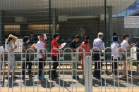 <p>People wait in line outside the U.S. Embassy in Beijing, China, July 26, 2018. (Photo: Jason Lee/Reuters) </p>