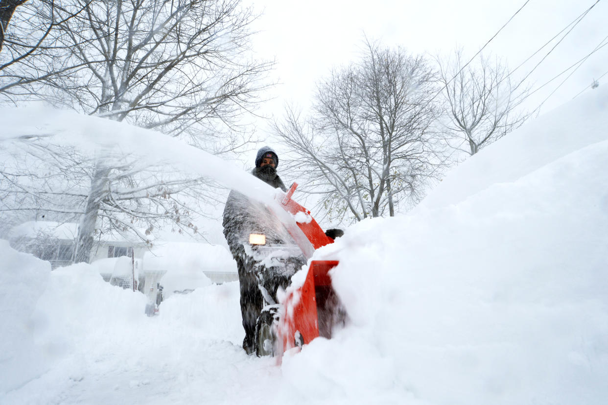 A man uses a snowblower following a snowstorm (John Normile / Getty Images file)