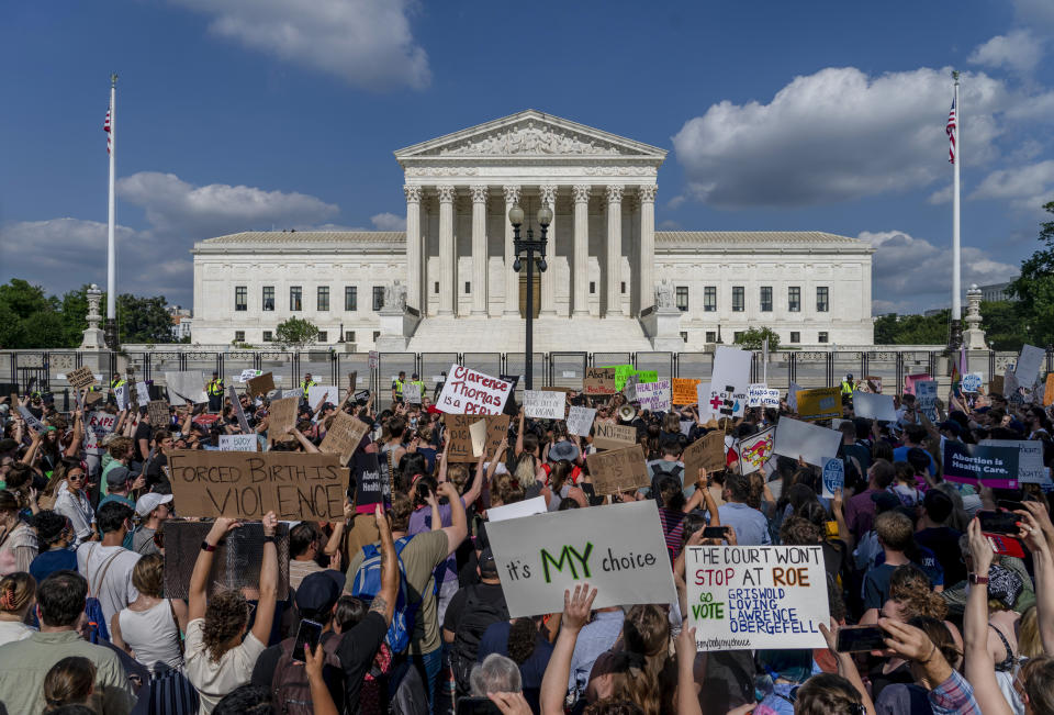 FILE - Abortion-rights and anti-abortion demonstrators gather outside of the Supreme Court in Washington, Friday, June 24, 2022. Confidence in the Supreme Court sank to its lowest point in at least 50 years in 2022, in the wake of the Dobbs decision that led to state bans and other restrictions on abortion. That's according to the General Social Survey, a long-running and widely respected survey conducted by NORC at the University of Chicago that has been measuring confidence in the court since 1973, the same year that Roe v. Wade legalized abortion nationwide.(AP Photo/Gemunu Amarasinghe, File)