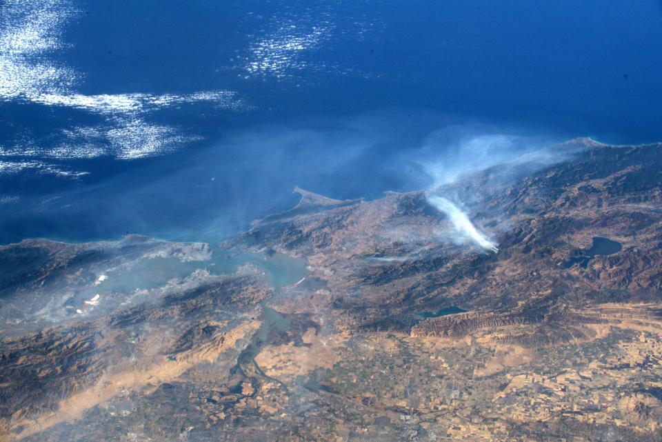 This undated handout image, courtesy of NASA and taken by astronaut Andrew Morgan aboard the International Space Station, shows smoke from the Kincade Fire (right) in Sonoma County, northern California. San Francisco is at the left.