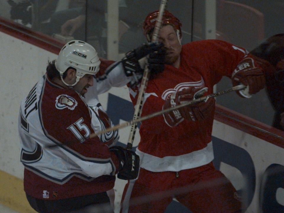 Colorado Avalanche's Yves Sarault checks Detroit Red Wings' Doug Brown into the boards during the second period in Game 5 of the Western Conference finals at McNichols Sports Arena in Denver, May 24, 1997.