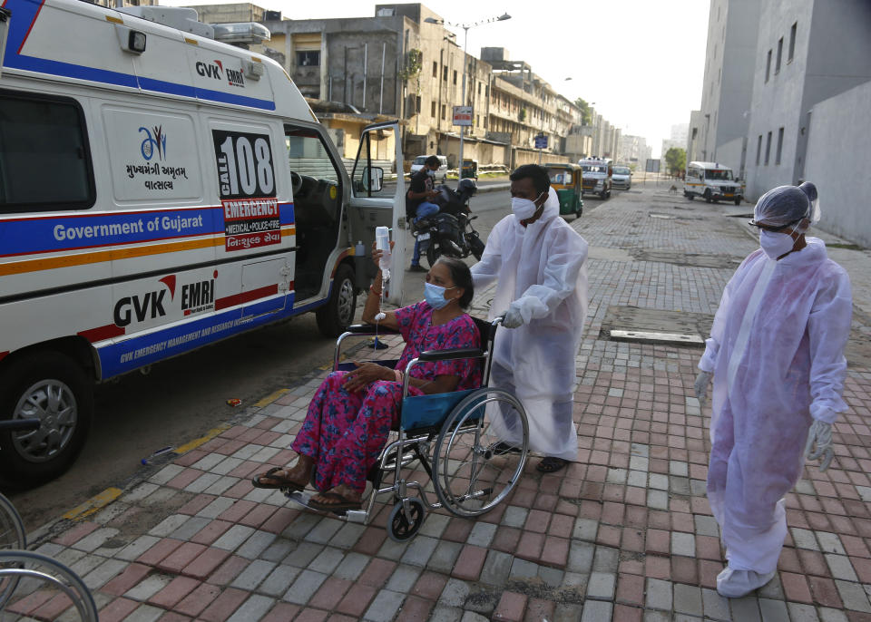 Paramedics shift a patient infected with black fungus to Mucormycosis ward of a government hospital in Ahmedabad, India, Friday, May 21, 2021. India's confirmed coronavirus cases and deaths remained below record levels in the last 24 hours, but authorities are worried about fungal infection that attacks those with weak immune systems. (AP Photo/Ajit Solanki)