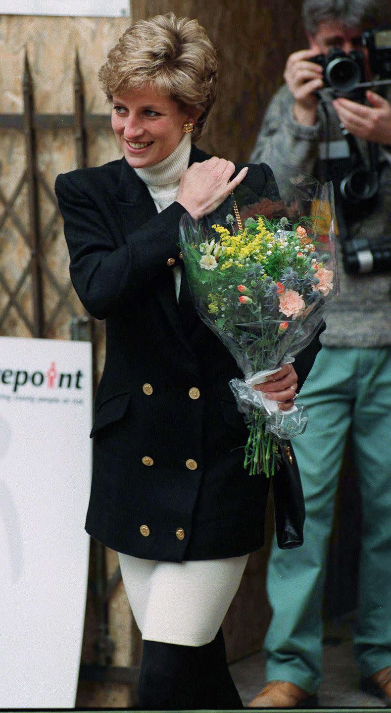 <p>Diana paired a black blazer with gold buttons over a cream turtleneck for a visit to Centrepoint in January 1995.<br></p>