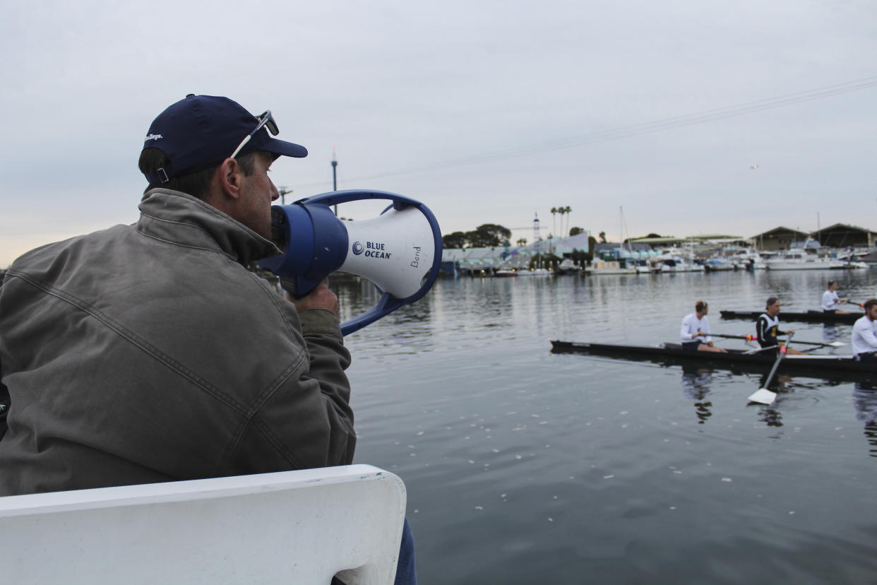 In this February 2020 photo provided by University of California San Diego is men's rowing coach Geoff Bond, during practice in San Diego. Brian Lilly Jr., 19, who committed suicide on Jan. 4, 2021, was a rower at University of California San Diego. Lilly's family has filed a wrongful death lawsuit against the university and the rowing coach, Bond, who is no longer with the school. (University of California San Diego via AP)