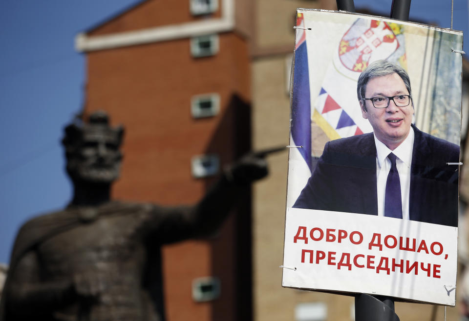 A poster,showing Serbian President Aleksandar Vucic reading '"Welcome, President", sets in front of the monument of late Serbian Duke Lazar was killed at the Battle of Kosovo in June 1389 during a rally of Serbian President Aleksandar Vucic in the northern, Serb-dominated part of Mitrovica, Kosovo, Sunday, Sept. 9, 2018. NATO-led peacekeepers in Kosovo say the safety of Serbia President Aleksandar Vucic during a visit to Kosovo isn't threatened despite roadblocks that prevented his visit to a central Serb-populated village. (AP Photo/Darko Vojinovic)