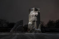 Snow covers the Martin Luther King Jr. Memorial in Washington, Sunday, Jan. 16, 2022. Ceremonies scheduled for the site on Monday, to mark the Martin Luther King Jr. national holiday, have been canceled because of the weather. (AP Photo/Carolyn Kaster)
