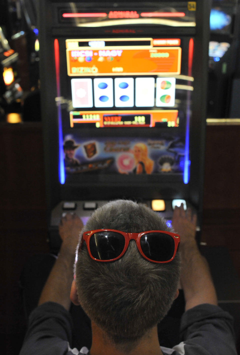 A man plays on a slot machine in a gambling hall in Budapest, Hungary, Wednesday, Oct. 3, 2012. Hungary’s ban on slot machines has taken the country’s gambling industry by surprise. On Tuesday, just over 24 hours after the announcement, lawmakers in the Hungarian Parliament voted in favor of a new bill which bans the country's slot machines. (AP Photo/Bela Szandelszky)