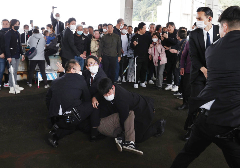 Wakayama police restrain a man who allegedly threw explosives where Kishida was scheduled to give a speech for by-election of Lower House, in Wakayama City on April 15.<span class="copyright">The Yomiuri Shimbun/AP</span>