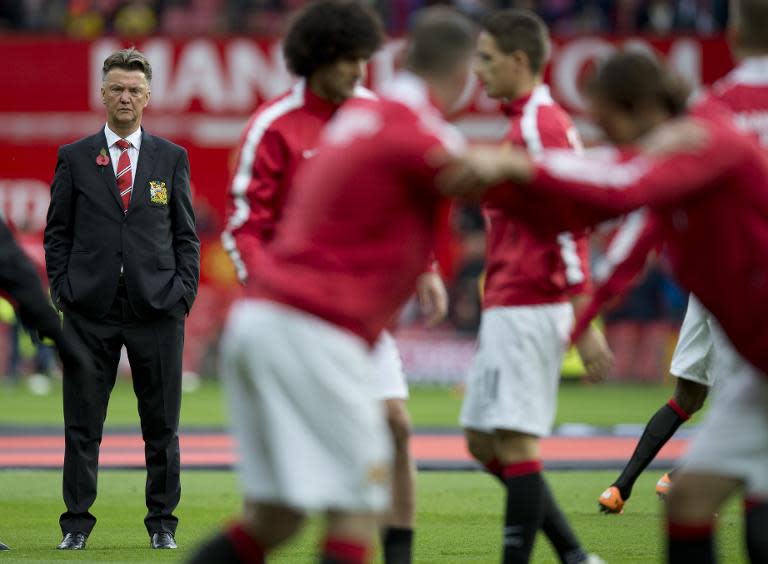 Manchester United's Dutch manager Louis van Gaal watches his team warm-up before the English Premier League football match between Manchester United and Crystal Palace at Old Trafford in Manchester, England, on November 8, 2014