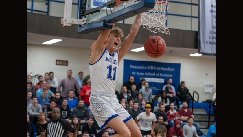 Yeshiva's Ryan Turell dunks the basketball.