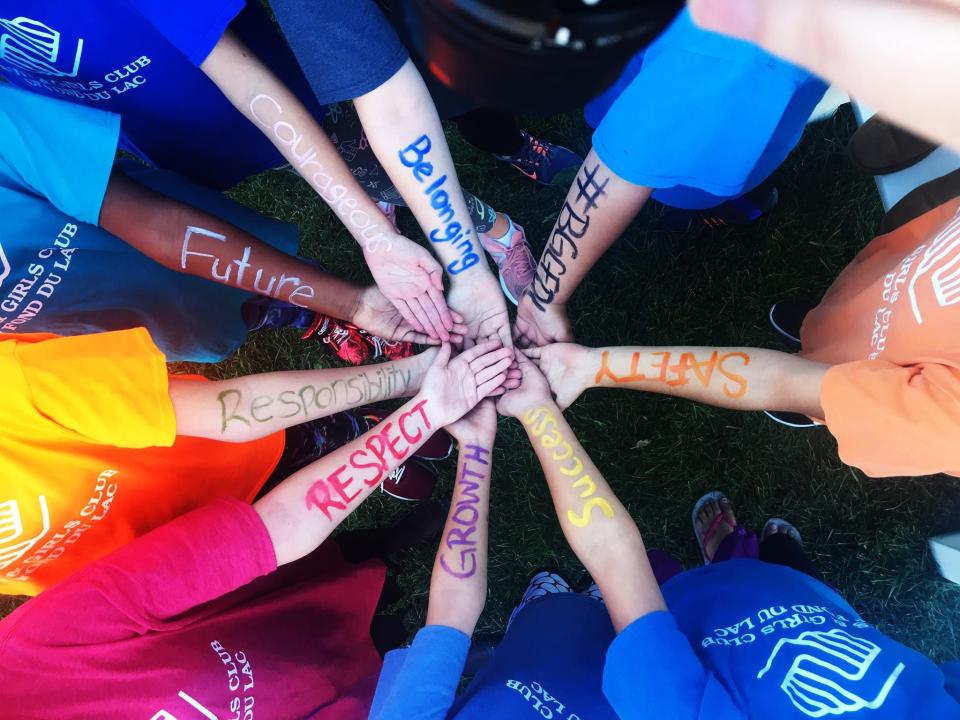 FILE - Children participating in the Boys & Girls Club of Fond du Lac's summer programming took some time to write their values on their arms.