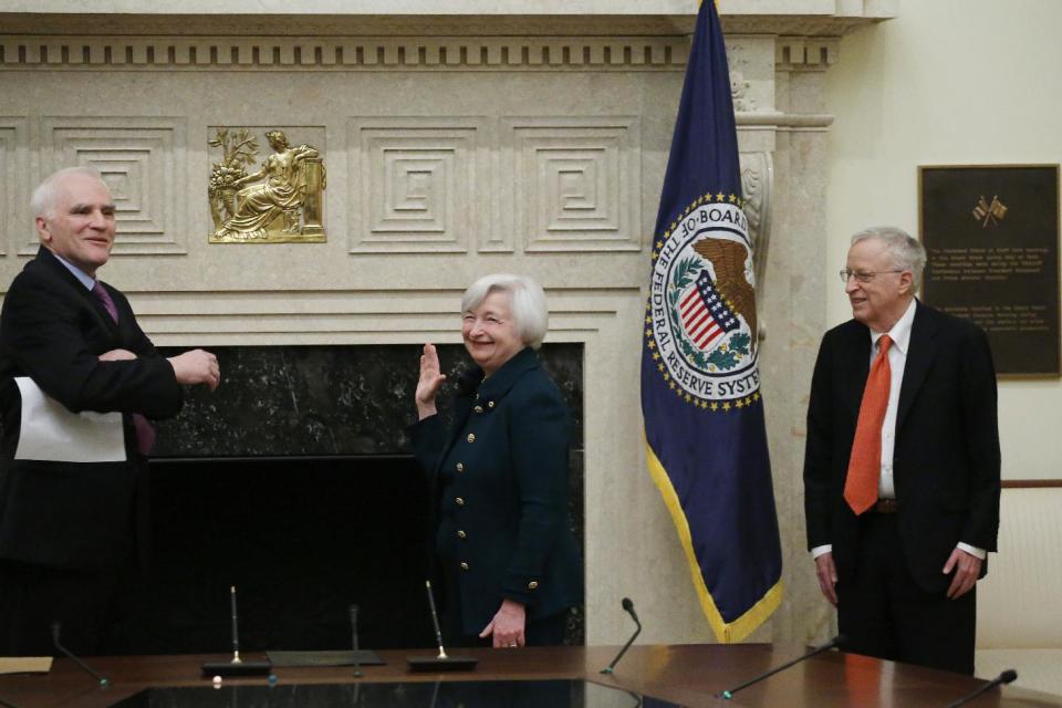 Janet Yellen, accompanied by her husband, Nobel Prize winning economist, George Akerlof, right, is administered the oath of office as Federal Reserve Board chair by Fed Board Gov. Daniel K. Tarullo, Monday, Feb. 3, 2014, at the Federal Reserve in Washington. Yellen is the first woman to lead the Federal Reserve. (AP Photo/Charles Dharapak)