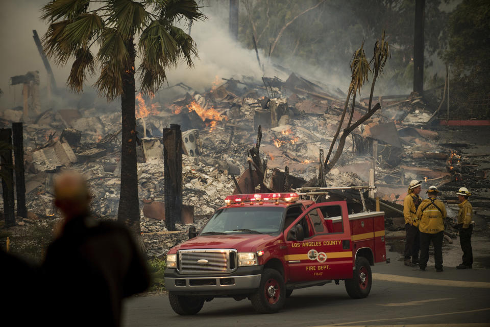 FILE - In this Dec. 5, 2017, file photo, an apartment complex burns as a wildfire rages in Ventura, Calif. California's massive property insurance market is feeling the effects of three straight years of damaging wildfires. Insurers have pulled out of some markets and canceled thousands of policies, forcing regulators to step in and expand a state program that homeowners often turn to as a last resort. (AP Photo/Noah Berger, File)