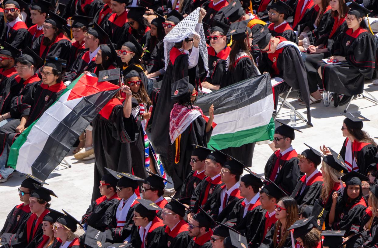 Graduates protesting the Israeli - Hamas war walk out during commencement Saturday, May 11, 2024 at Camp Randall Stadium at the University of Wisconsin - Madison in Madison, Wisconsin. The school also held a commencement ceremony at the Kohl Center Friday. In total, the university anticipates that nearly 8,600 students will be earning degrees — 6,236 bachelor’s degrees, 1,394 master’s degrees and 968 PhDs.