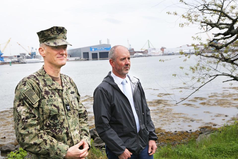 Capt. Chad Brooks and Russell Gagner, director of the Shipyard Infrastructure Optimization Program’s execution at Portsmouth Naval Shipyard, discuss the project from Peirce Island in Portsmouth on Thursday, May 16, 2024.