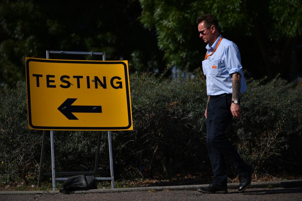 Pedestrians walk past a sign for a Covid-19 test centre in Southend-on-Sea, east of London on September 19, 2020. (Photo by Ben STANSALL / AFP) (Photo by BEN STANSALL/AFP via Getty Images)