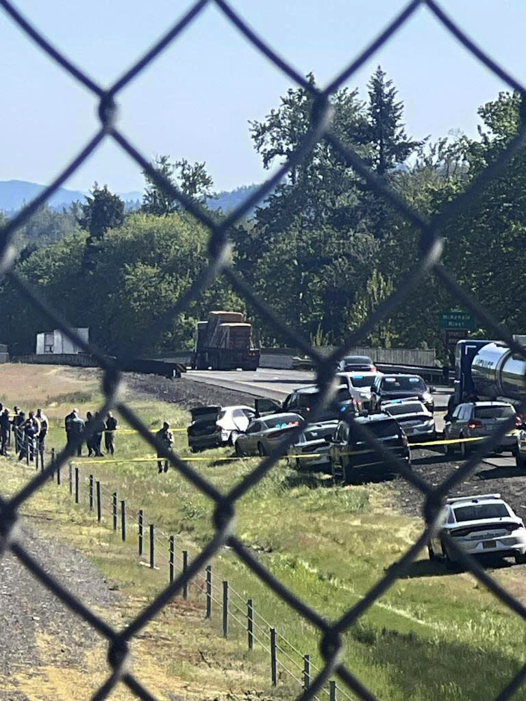 This image provided by KEZI 9 News shows the scene on Interstate 5 on Tuesday, April 23, 2024, near Eugene, Ore., after a former Washington state police officer wanted after killing two people, including his ex-wife, was found with a self-inflicted gunshot wound following a chase in Oregon, authorities said. His 1-year-old baby, who was with him, was taken safely into custody by Oregon State Police troopers. (KEZI 9 News via AP)