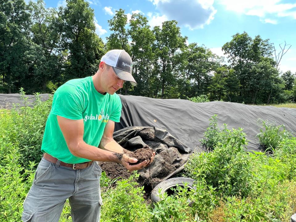 Will Brownback, owner of Spiral Path Farm, unwraps compost curing that is to be spread on his fields in the spring of 2024. Adding organic matter improves soil health and helps to mitigate climate change.