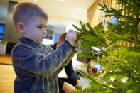 Richard Sepp decorates Christmas tree found with help of a mobile application in Kuuresaare