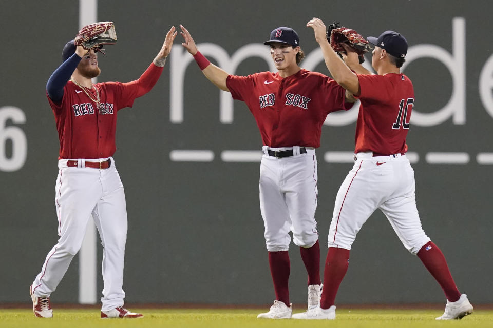 Boston Red Sox outfielders, from left to right, Alex Verdugo, Jarren Duran and Hunter Renfroe celebrate their victory over the Baltimore Orioles in a baseball game at Fenway Park, Friday, Aug. 13, 2021, in Boston. (AP Photo/Elise Amendola)