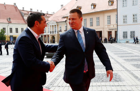 Greek Prime Minister Alexis Tsipras and Estonian Prime Minister Juri Ratas shake hands as they arrive for the informal meeting of European Union leaders in Sibiu, Romania, May 9, 2019. REUTERS/Francois Lenoir