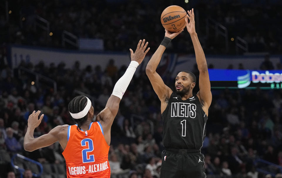 Brooklyn Nets forward Mikal Bridges (1) shoots over Oklahoma City Thunder guard Shai Gilgeous-Alexander (2) during the first half of an NBA basketball game Tuesday, March 14, 2023, in Oklahoma City. (AP Photo/Sue Ogrocki)