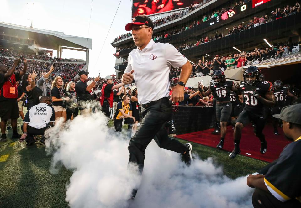 Louisville head coach Scott Satterfield runs out of the tunnel for his first game as the Cards took on visiting Notre Dame for the team's season opener Sept. 2, 2019.