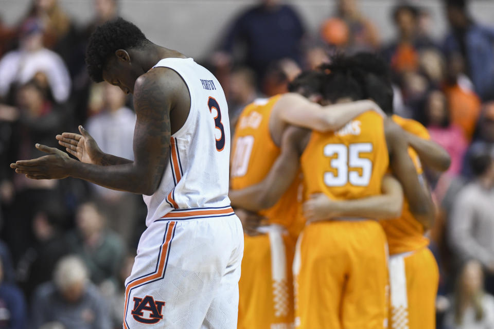 Auburn forward Danjel Purifoy (3) takes the court as Tennessee huddles before the first half of an NCAA college basketball game Saturday, Feb. 22, 2020, in Auburn, Ala. (AP Photo/Julie Bennett)