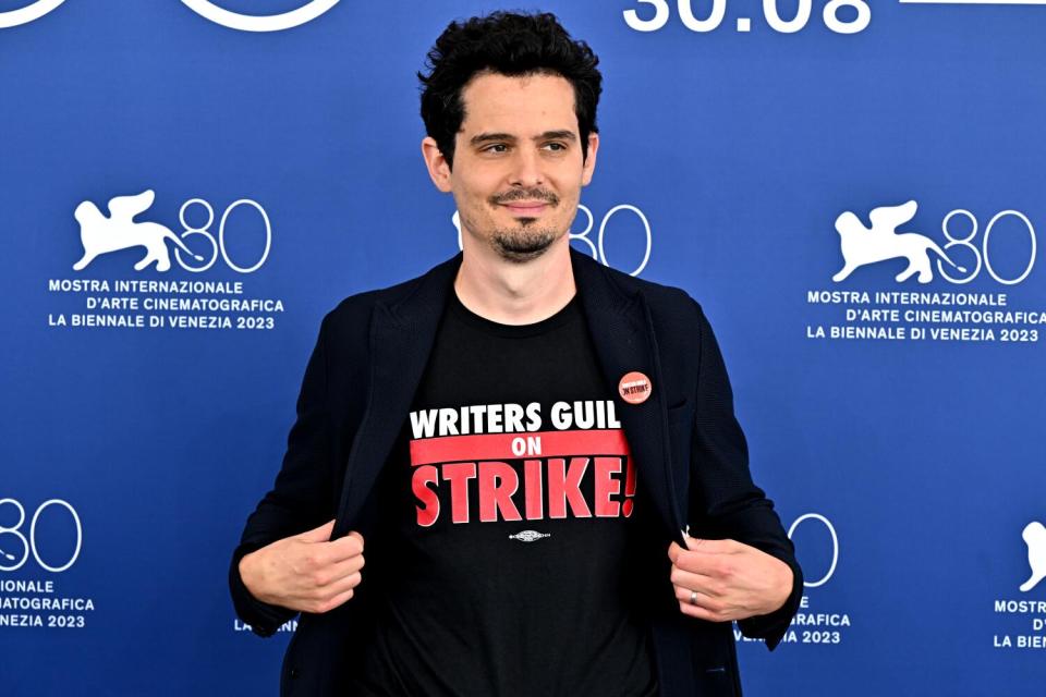 A man in a Writers Guild on Strike T-shirt and black blazer.