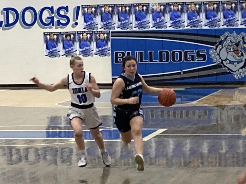 Lansing Catholic sophomore Gabby Halliwill dribbles the ball against Ionia senior guard Josie Phelps (No. 10) during a girls varsity basketball game Friday, Jan. 21, at Ionia High School. Lansing Catholic won the game, 66-31.