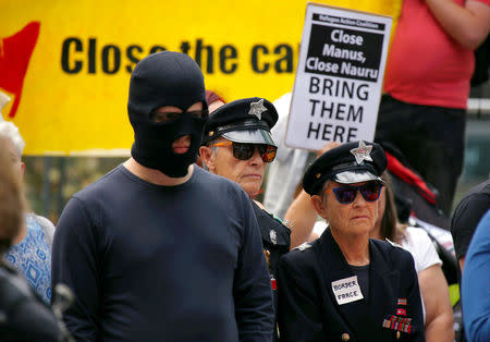 Protesters wearing costumes from the Refugee Action Coalition stand together during a demonstration outside the offices of the Australian Government Department of Immigration and Border Protection in Sydney, Australia, April 29, 2016. REUTERS/David Gray