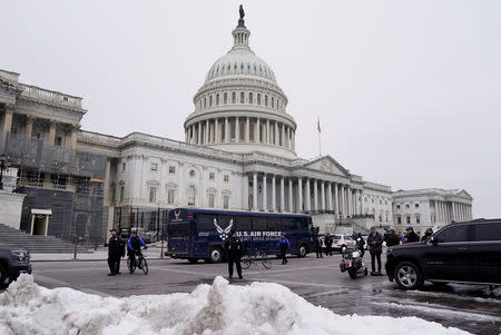 A U.S. Air Force bus meant to transport U.S. Speaker of the House Nancy Pelosi and other members of a congressional delegation to a flight to Belgium and Afghanistan sits guarded by U.S. Capitol Police in front of the Capitol after President Donald Trump cancelled the Air Force flight as the president's dispute with congressional Democrats over the partial government shutdown continues in Washington, U.S., January 17, 2019. REUTERS/Joshua Roberts