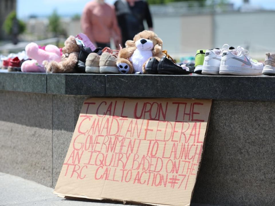 Visitors created a memorial at the Centennial Flame on Parliament Hill on May 30, 2021, following the discovery of potential unmarked burials at the site of a former residential school in Kamloops, B.C. (Olivier Hyland/CBC - image credit)