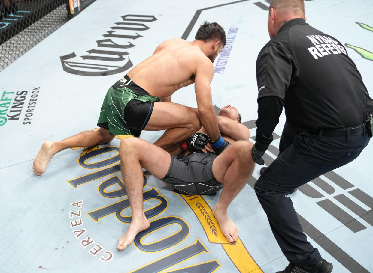 ELMONT, NEW YORK - JULY 16: (R-L) Brian Ortega suffers an apparent shoulder injury against Yair Rodriguez of Mexico in a featherweight fight during the UFC Fight Night event at UBS Arena on July 16, 2022 in Elmont, New York. (Photo by Jeff Bottari/Zuffa LLC)