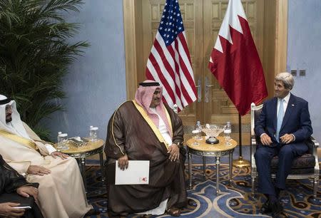 Bahrain's Foreign Minister Sheikh Khalid bin Ahmed al-Khalifa (C) and U.S. Secretary of State John Kerry wait for a meeting at King Abdulaziz International Airport in Jeddah September 11, 2014. REUTERS/Brendan Smialowski/Pool