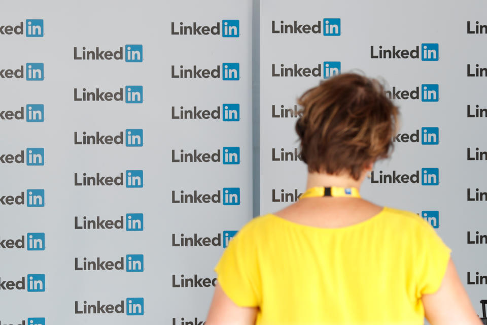 A visitor looks at logos of LinkedIn Corporation at the MEDEF union summer forum on the campus of the HEC School of Management in Jouy-en-Josas, near Paris, France, August 29, 2017. REUTERS/Charles Platiau