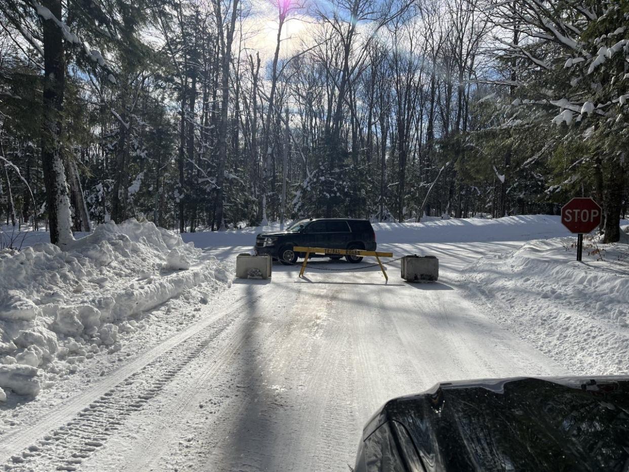 Lac du Flambeau tribal officials block a road on the reservation, stranding some residents.