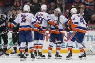 New York Islanders' Brock Nelson (29) celebrates with teammates, including Kyle Palmieri, second from right, after scoring during the second period of an NHL hockey game against the New Jersey Devils in Newark, N.J., Monday, April 15, 2024. (AP Photo/Seth Wenig)