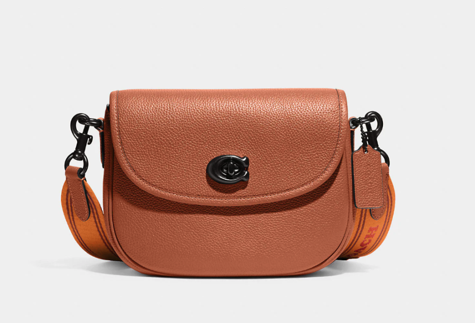 product photo of tan and orange Willow Saddle Bag. Image via Coach.