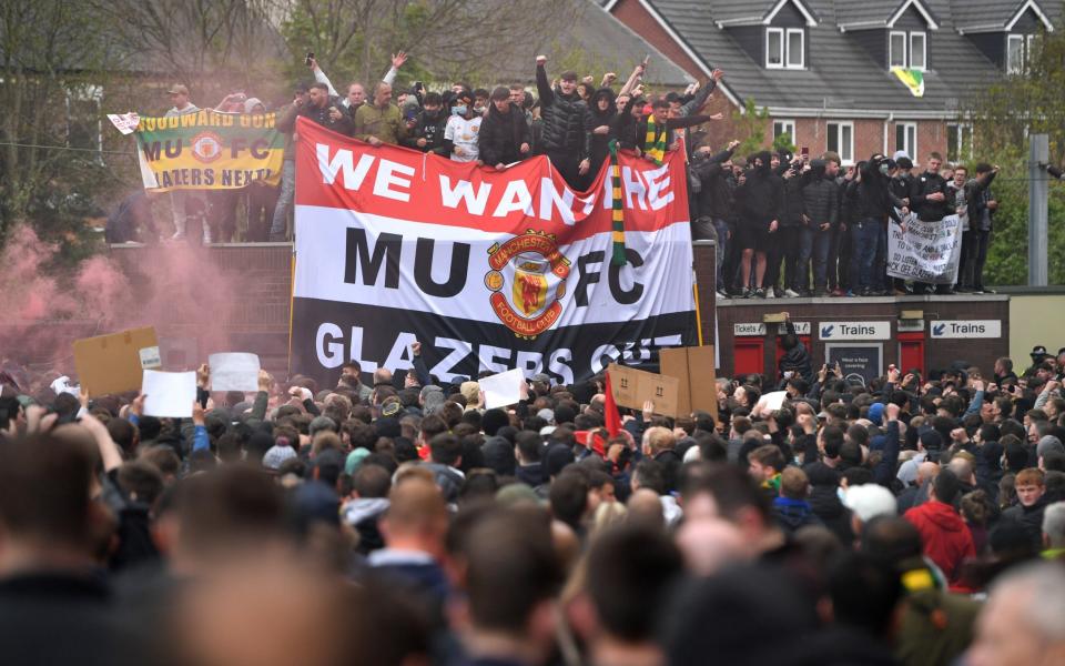 Manchester United fans protest about the owners of the club before the Premier League match between Manchester United and Liverpool at Old Trafford on May 2, 2021 in Manchester, United Kingdom. - GETTY IMAGES