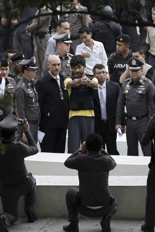 Thai authorities are already holding two foreign men in custody over the attack, one identified as Yusufu Mieraili (C, in yellow), pictured here during a reenactment with police near the site of the blast