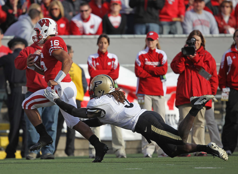 MADISON, WI - NOVEMBER 05: Russell Wilson #16 of the Wisconsin Badgers breaks away from Dewayne Beckford #3 of the Purdue Boilermakers at Camp Randall Stadium on November 5, 2011 in Madison Wisconsin. Wisconsin defeated Purdue 62-17. (Photo by Jonathan Daniel/Getty Images)